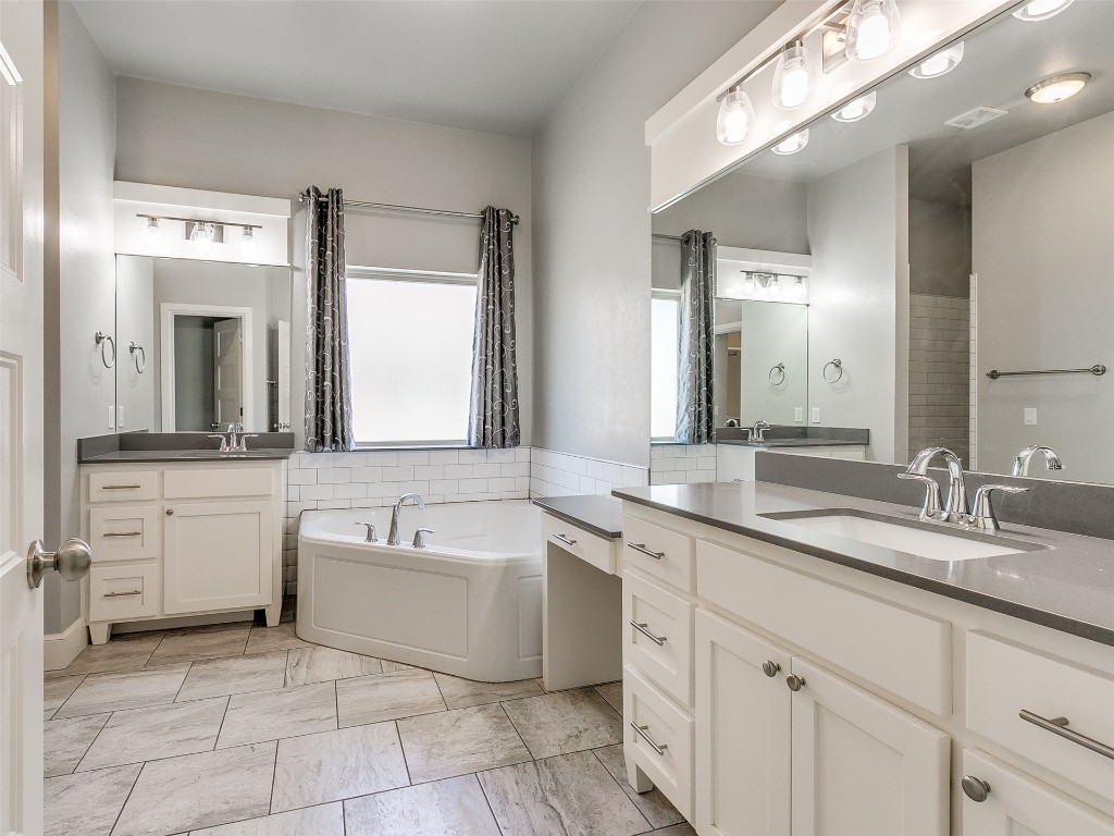 4325 SW 129th Street, Oklahoma City, OK 73173 bathroom featuring a washtub, tile floors, and dual vanity