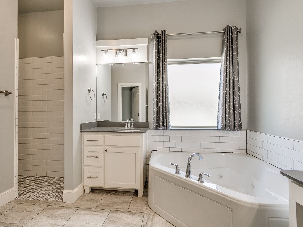 4325 SW 129th Street, Oklahoma City, OK 73173 bathroom featuring tile floors and vanity