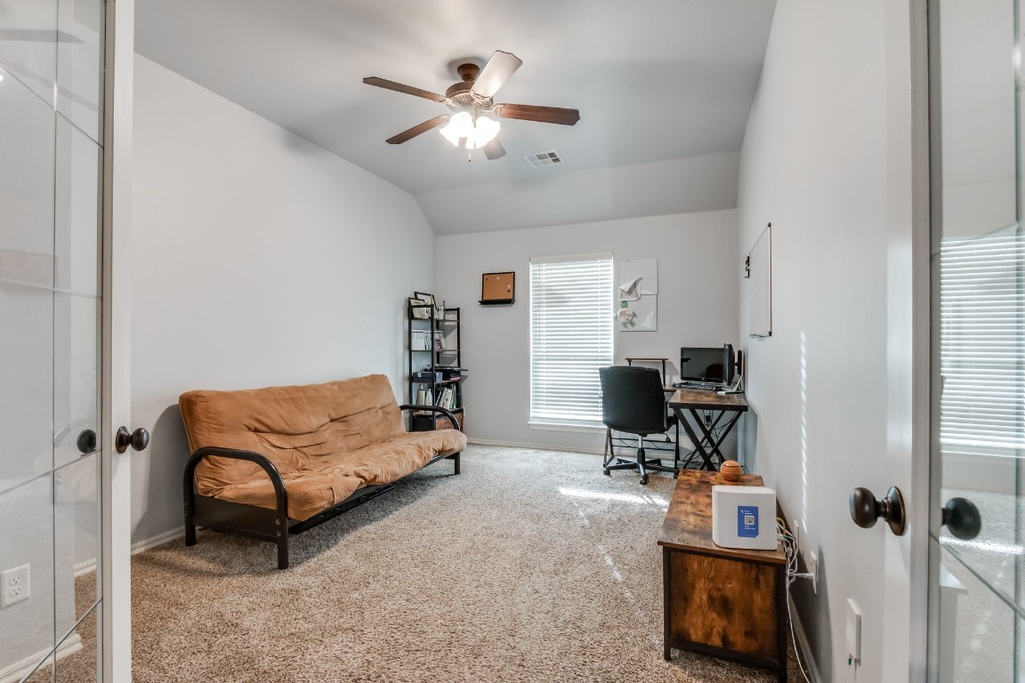 320 Maple Drive, Guthrie, OK 73044 carpeted home office featuring french doors, vaulted ceiling, and ceiling fan