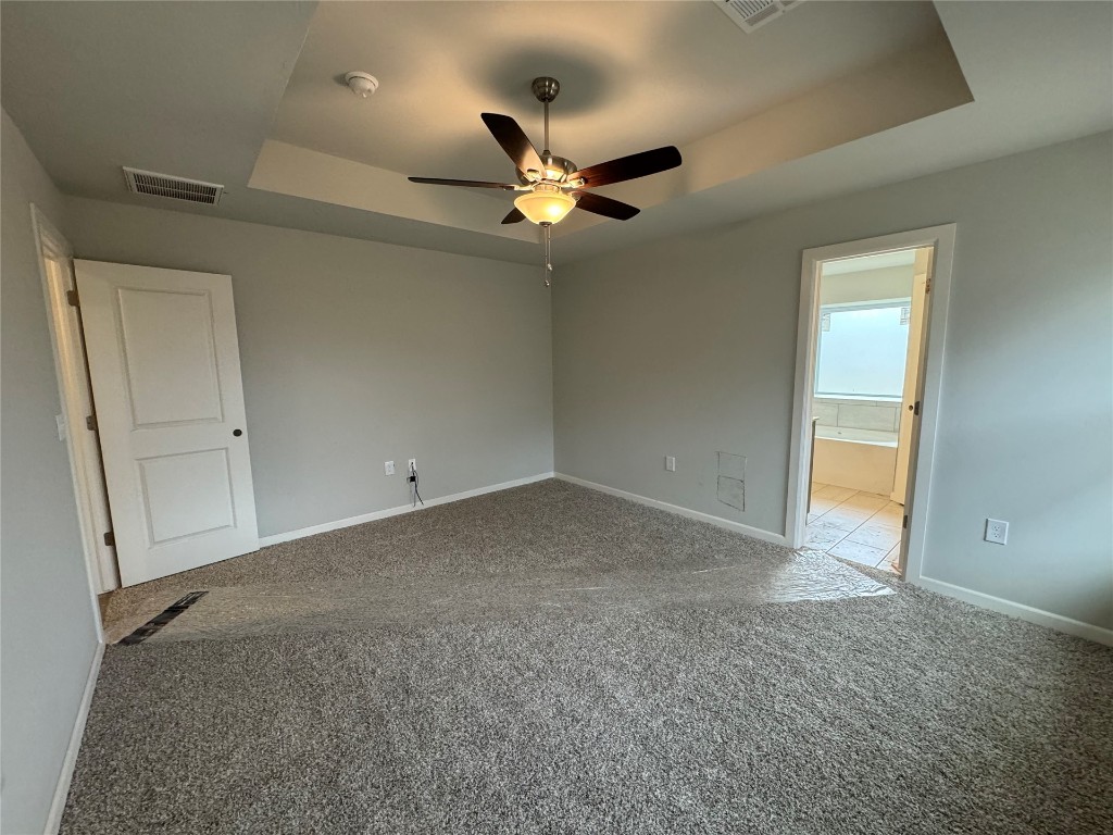 1696 Bloomington Court, Newcastle, OK 73065 carpeted spare room with a raised ceiling and ceiling fan