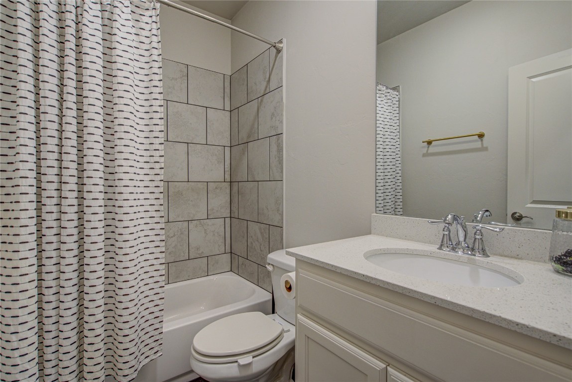 12920 Firerock Circle, Oklahoma City, OK 73142 full bathroom featuring vanity, shower / bath combo with shower curtain, and toilet