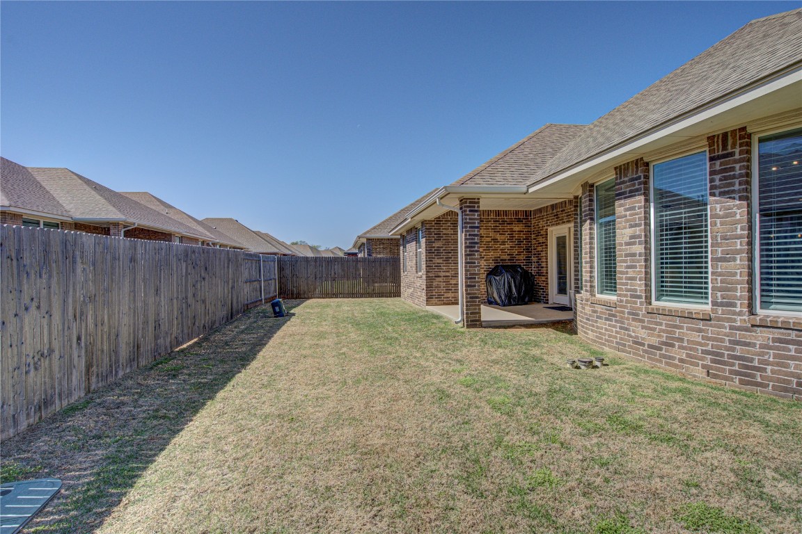 12920 Firerock Circle, Oklahoma City, OK 73142 view of yard with a patio