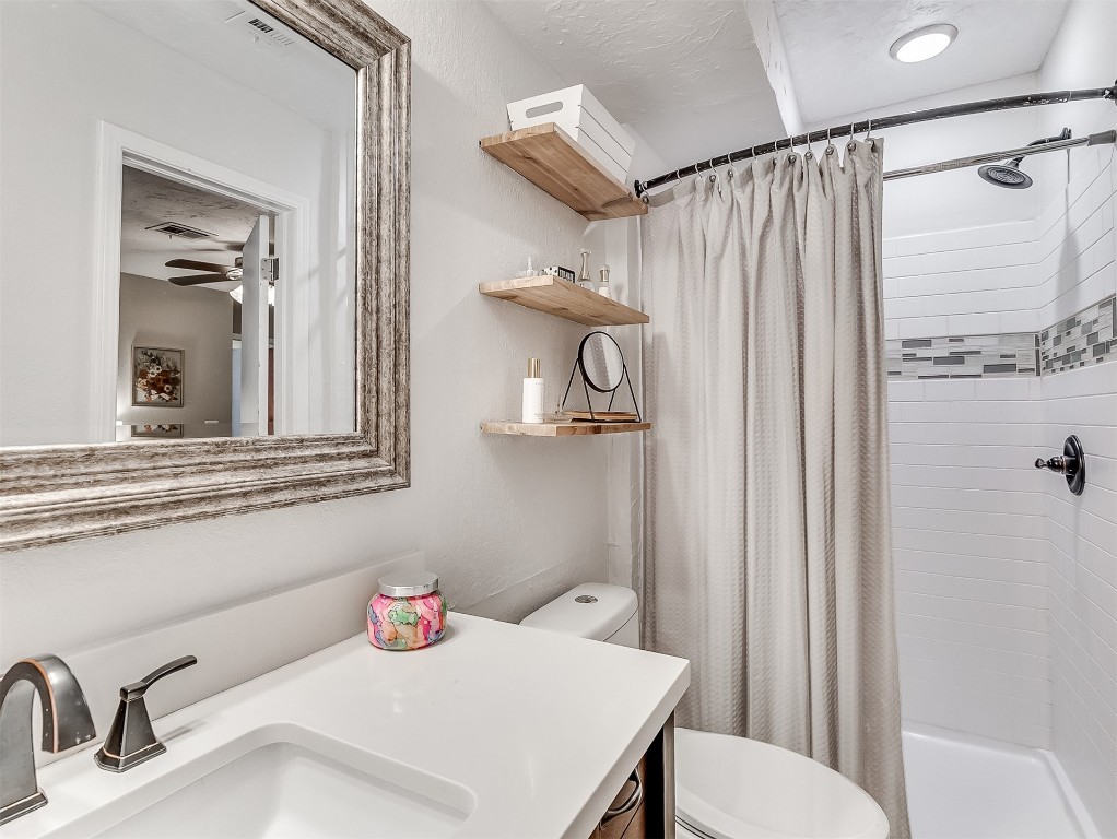114 E Cypress Avenue, Yukon, OK 73099 bathroom with ceiling fan, toilet, and vanity