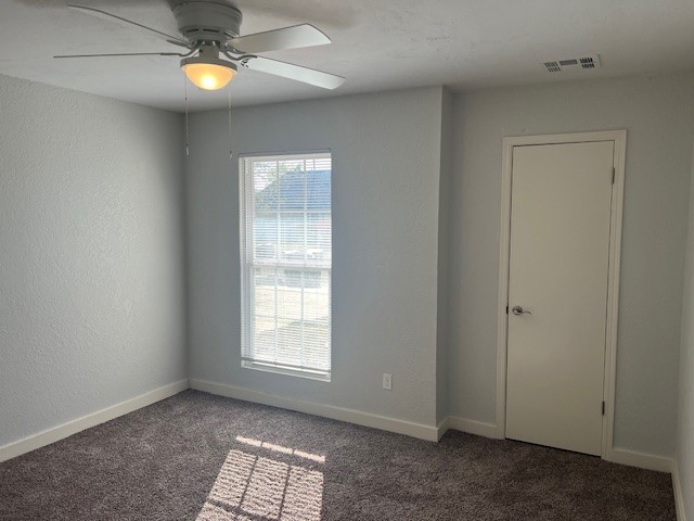 10117 Southridge Drive, Oklahoma City, OK 73159 empty room featuring dark carpet and ceiling fan