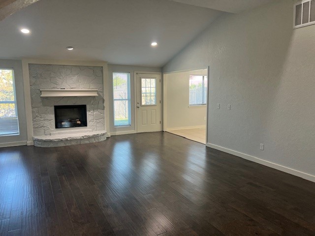 10117 Southridge Drive, Oklahoma City, OK 73159 unfurnished living room featuring plenty of natural light, dark hardwood / wood-style floors, and a fireplace
