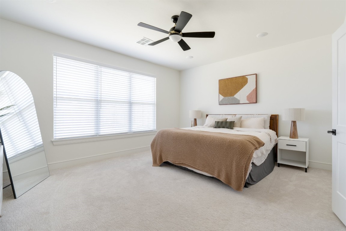 2532 Amante Court, Edmond, OK 73034 bedroom featuring light carpet and ceiling fan