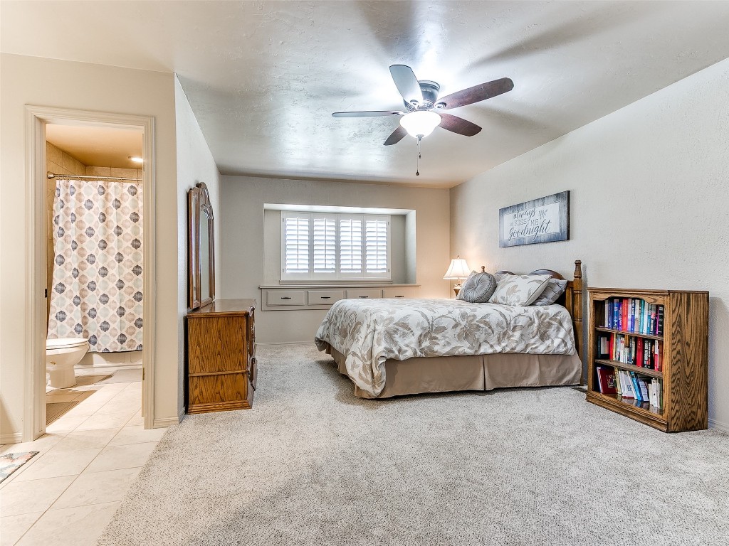 1738 W Rose Oak Drive, Mustang, OK 73064 bedroom featuring ceiling fan, ensuite bath, and light tile floors