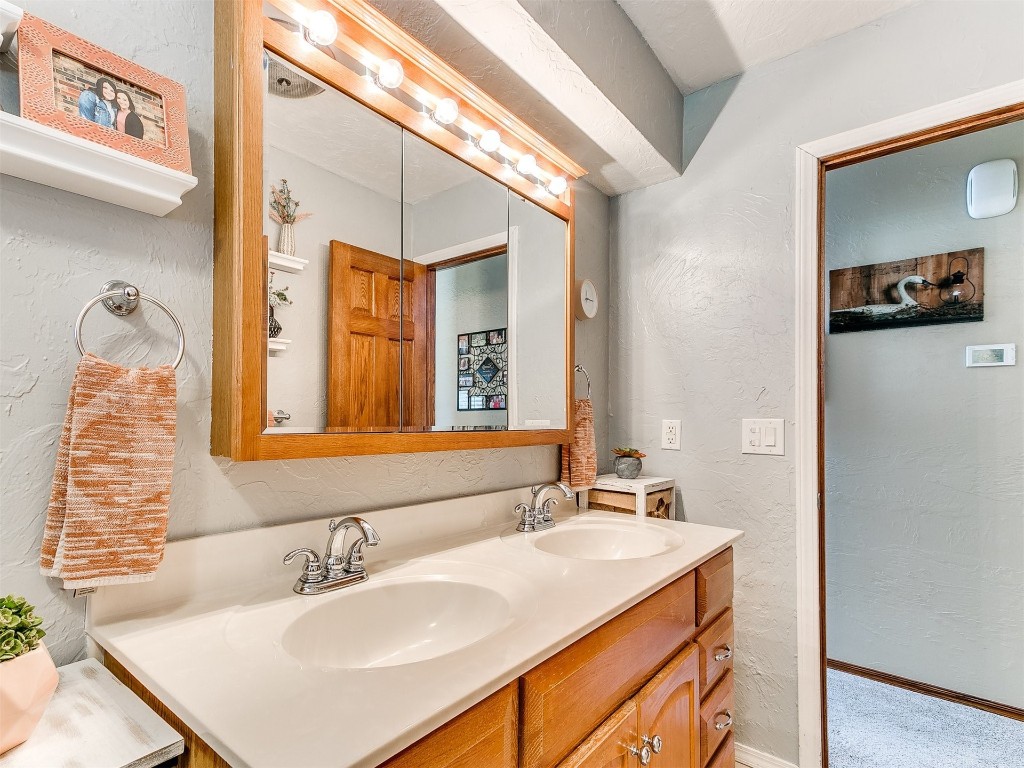 1738 W Rose Oak Drive, Mustang, OK 73064 bathroom featuring dual sinks and oversized vanity