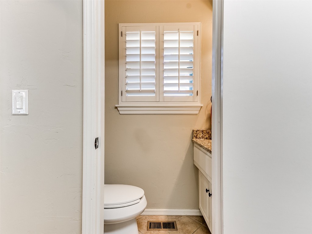 1738 W Rose Oak Drive, Mustang, OK 73064 bathroom featuring tile floors, toilet, and vanity
