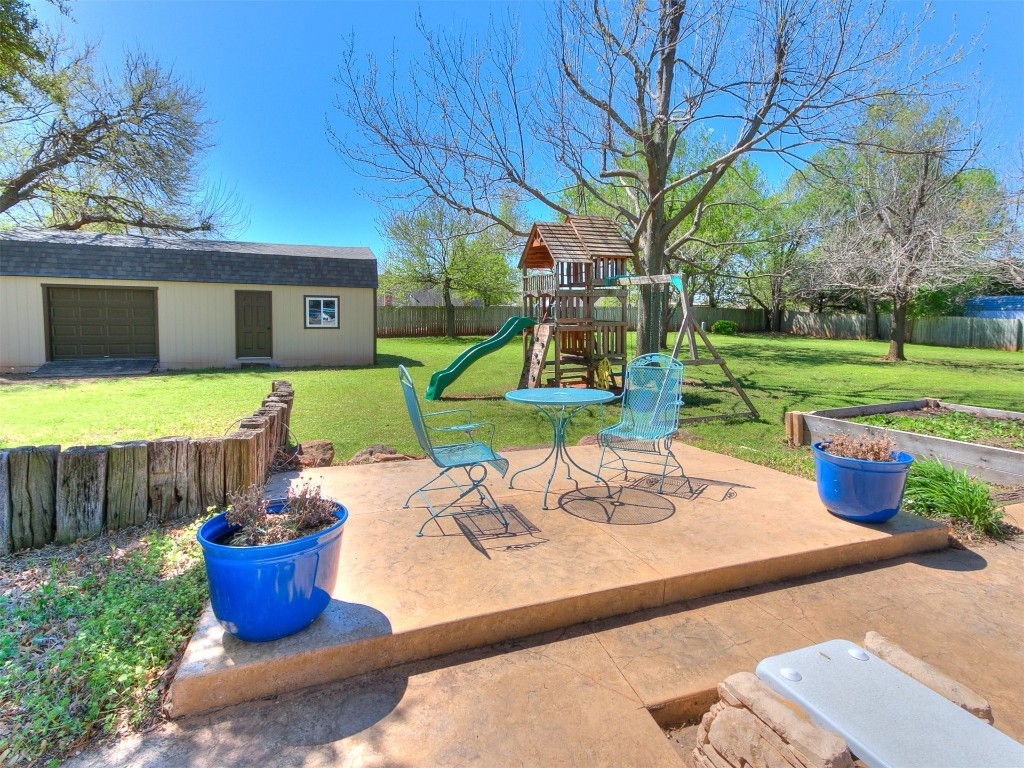 1738 W Rose Oak Drive, Mustang, OK 73064 view of patio / terrace featuring a playground
