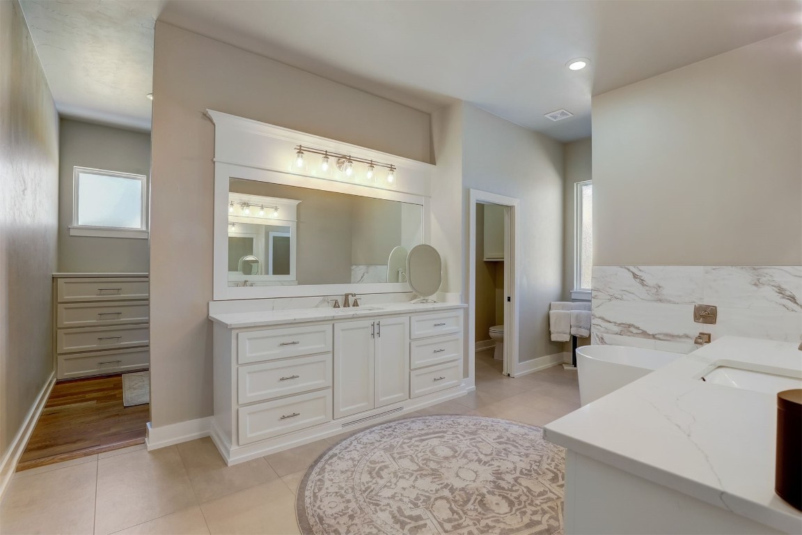 2273 NW 223rd Street, Edmond, OK 73025 bathroom featuring vanity and wood-type flooring