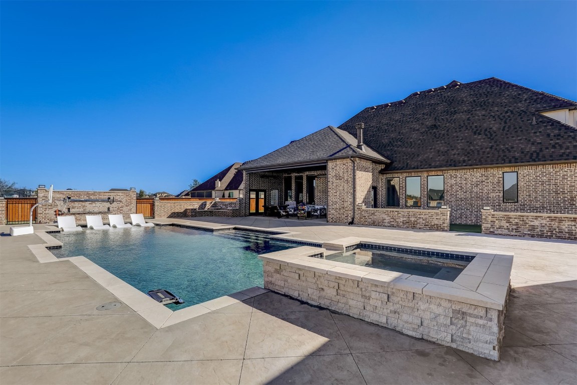 2273 NW 223rd Street, Edmond, OK 73025 view of pool with an in ground hot tub and a patio