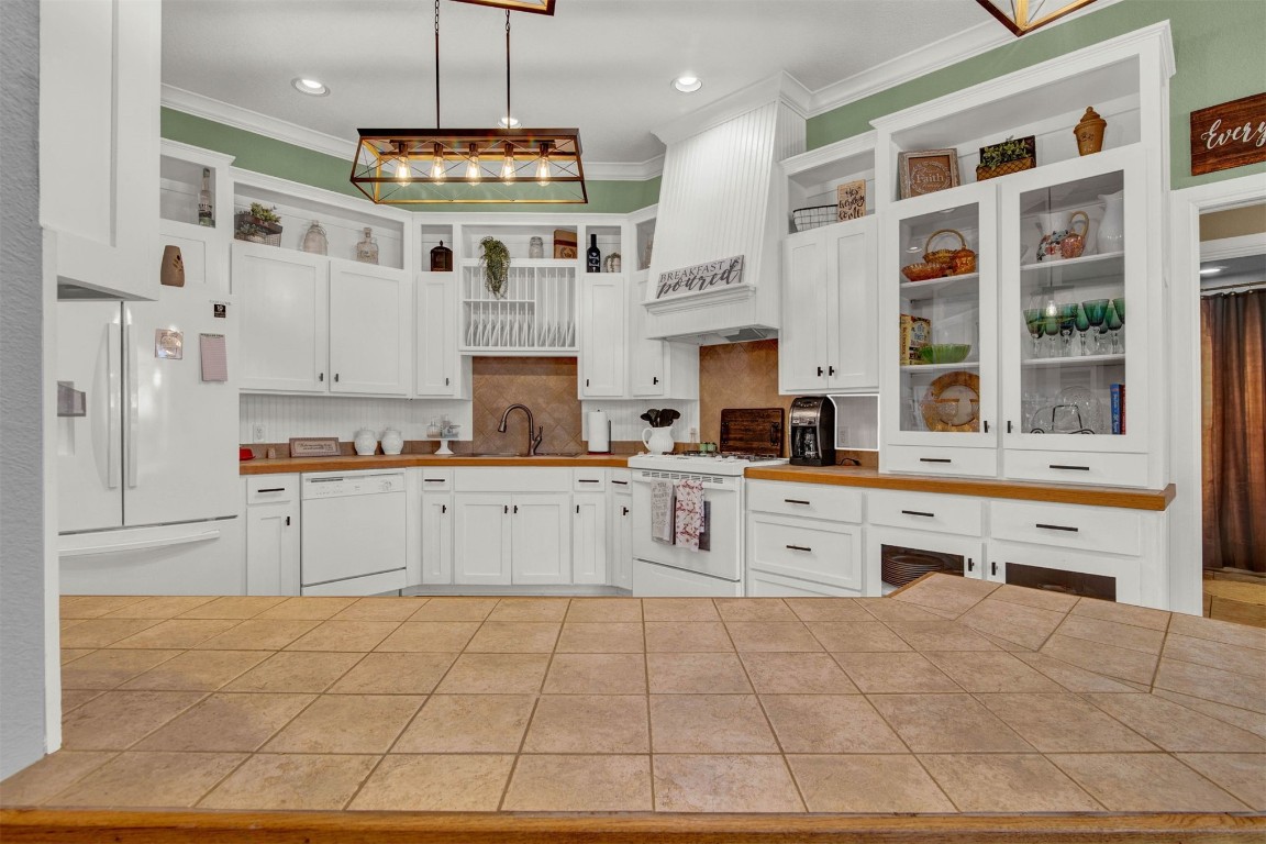 1312 SW 126th Street, Oklahoma City, OK 73170 kitchen with white appliances, white cabinetry, backsplash, and sink