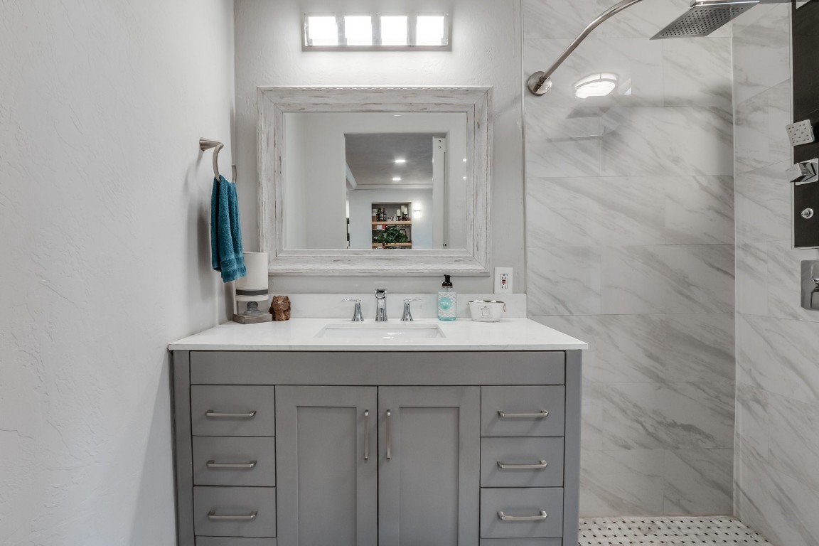 2736 Pembroke Terrace, Oklahoma City, OK 73116 bathroom with tiled shower and vanity