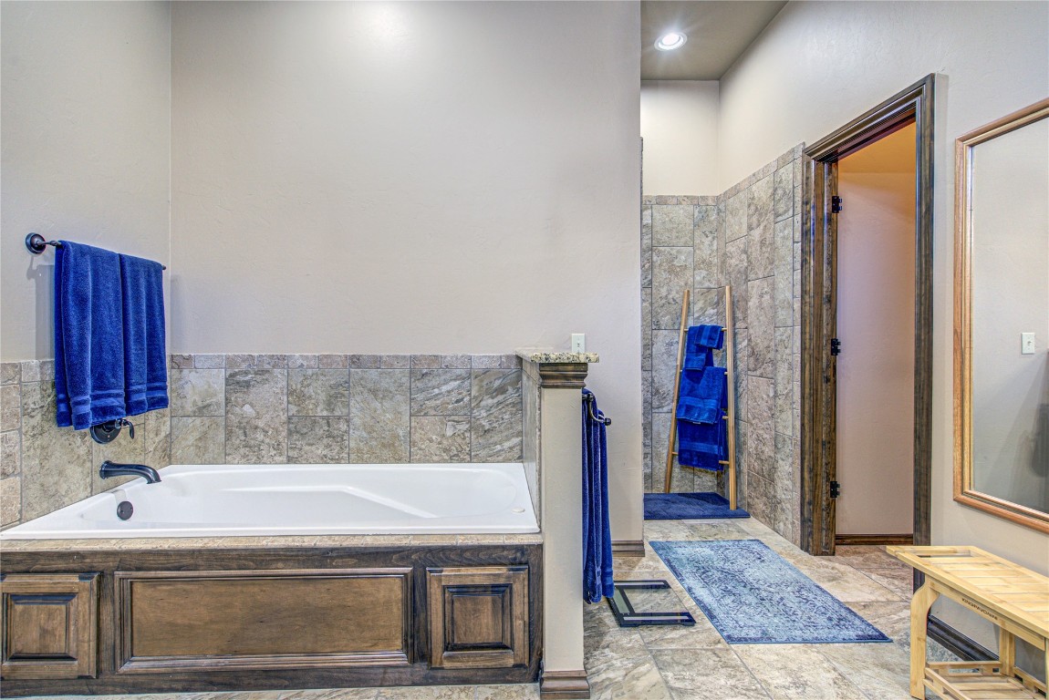 4904 SW 130th Street, Oklahoma City, OK 73173 bathroom featuring a tub and tile floors