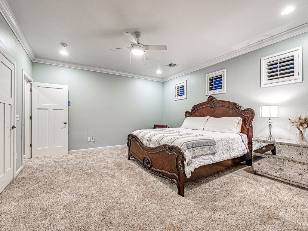 4101 Oakdale Farm Circle, Edmond, OK 73013 carpeted bedroom featuring ornamental molding and ceiling fan