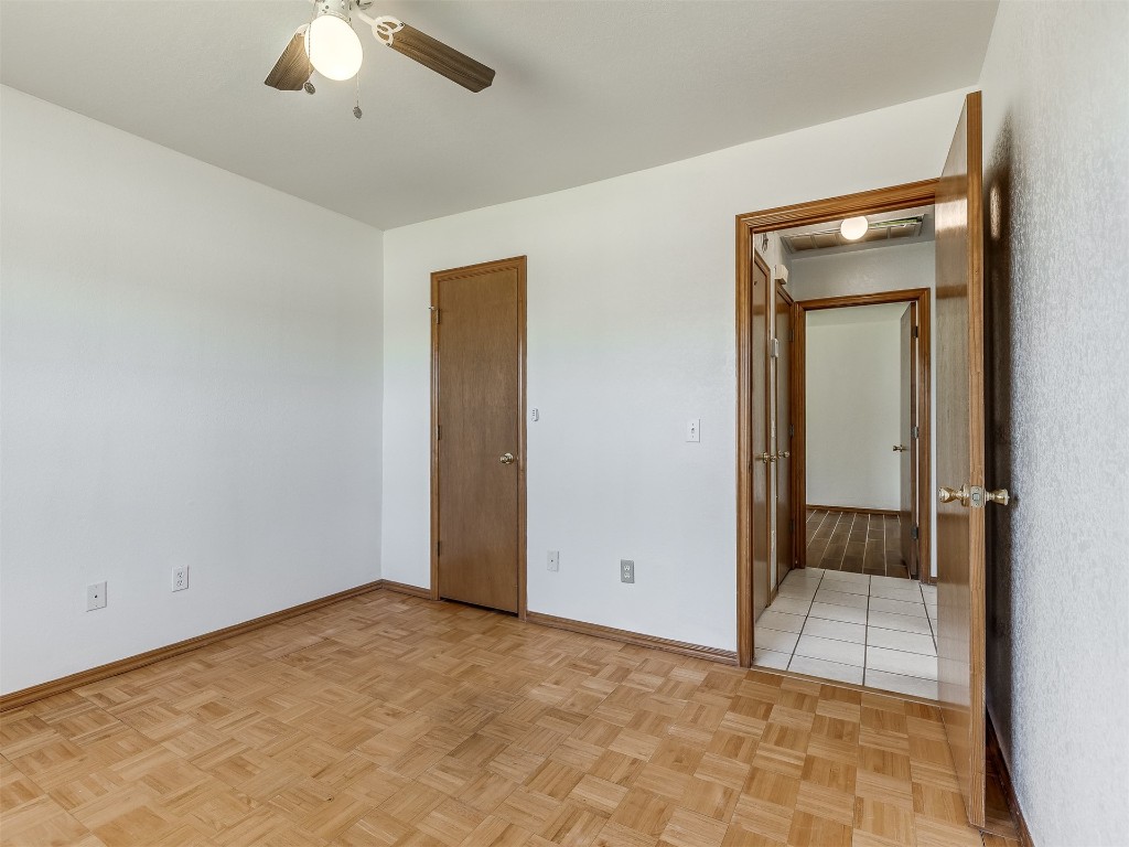 100 Parkdale Court, Noble, OK 73068 unfurnished bedroom with ceiling fan and light parquet flooring