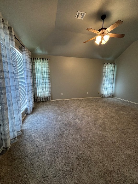 8304 NW 75th Street, Oklahoma City, OK 73132 empty room with ceiling fan, carpet flooring, and vaulted ceiling