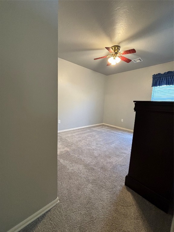 8304 NW 75th Street, Oklahoma City, OK 73132 spare room with carpet floors and ceiling fan