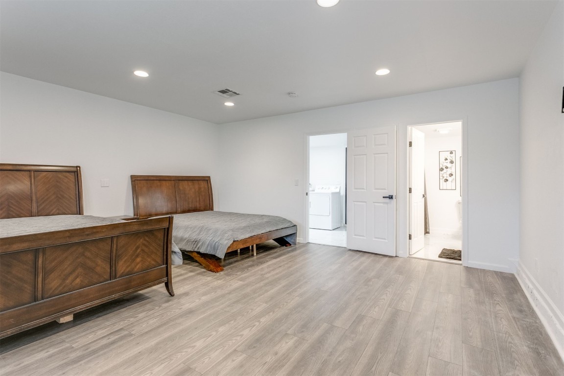 3313 Sherman Avenue, Oklahoma City, OK 73111 bedroom featuring ensuite bathroom, washer / dryer, and light hardwood / wood-style flooring