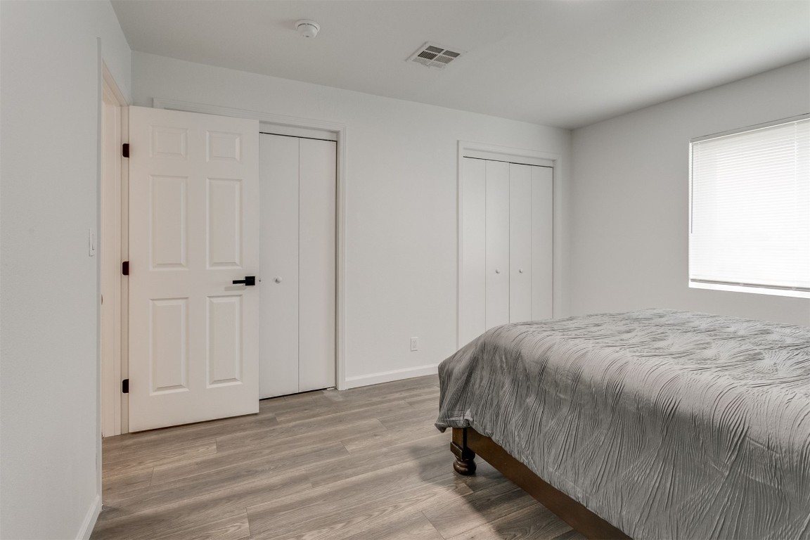3313 Sherman Avenue, Oklahoma City, OK 73111 bedroom with multiple closets and light hardwood / wood-style flooring