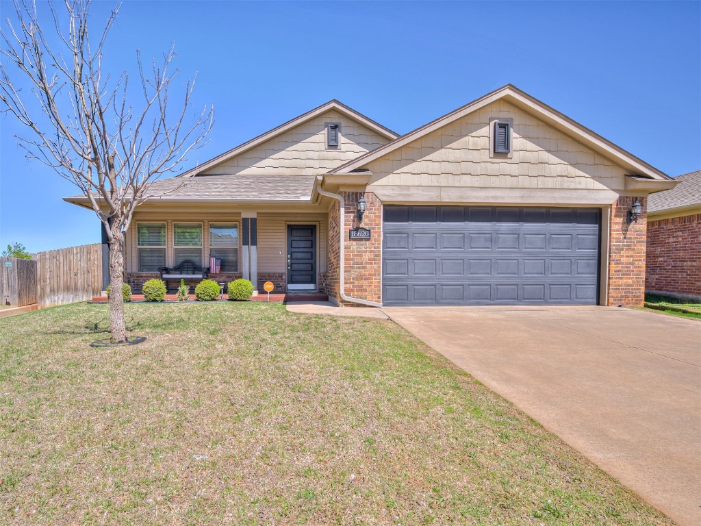 18620 Ochoa Drive, Edmond, OK 73012 ranch-style home with a front lawn and a garage