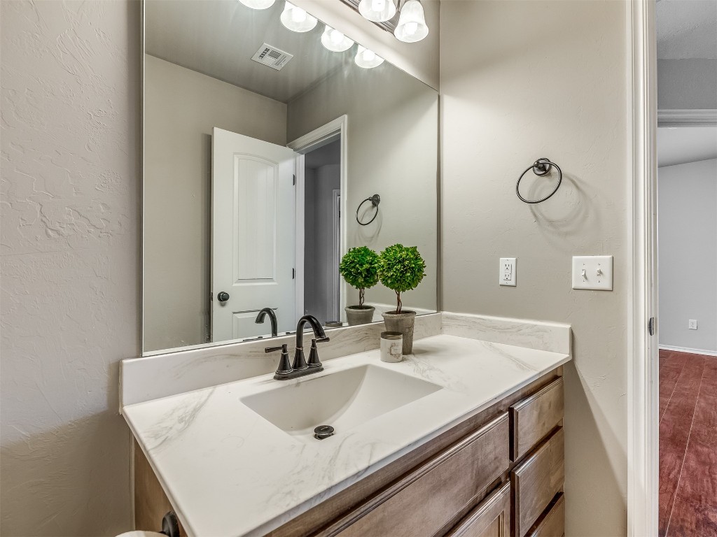 2333 NW 196th Terrace, Edmond, OK 73012 bathroom featuring large vanity and hardwood / wood-style flooring