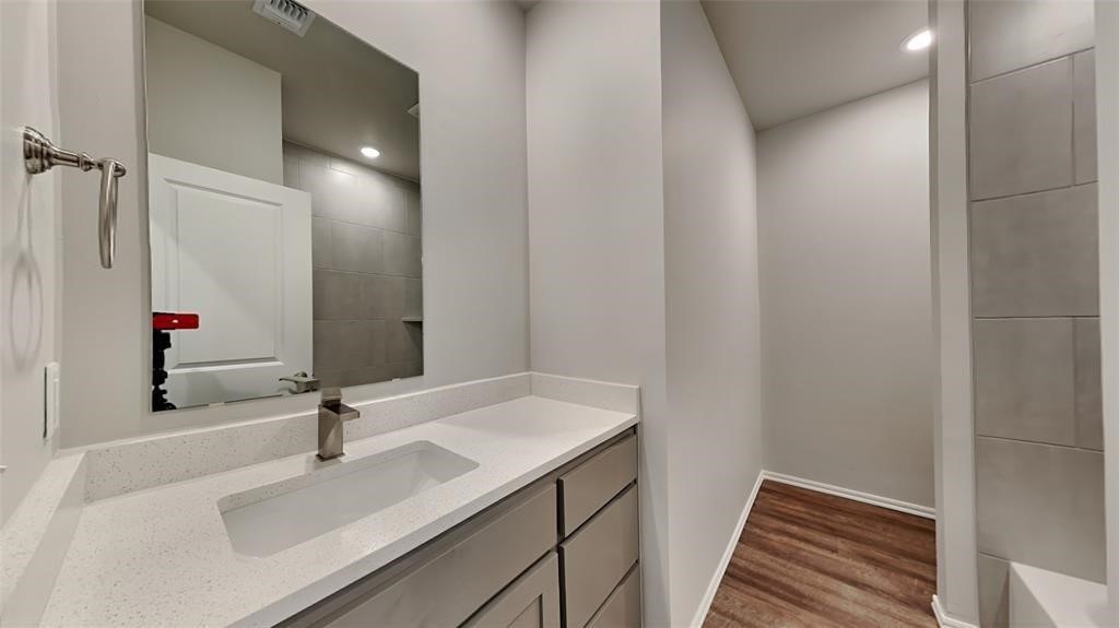 9333 NW 124th Street, Yukon, OK 73099 bathroom featuring vanity and hardwood / wood-style flooring