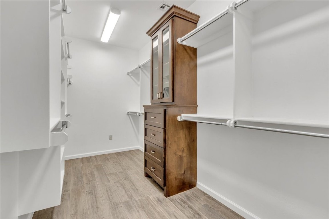 13504 Rock Canyon Road, Oklahoma City, OK 73142 spacious closet featuring light wood-type flooring