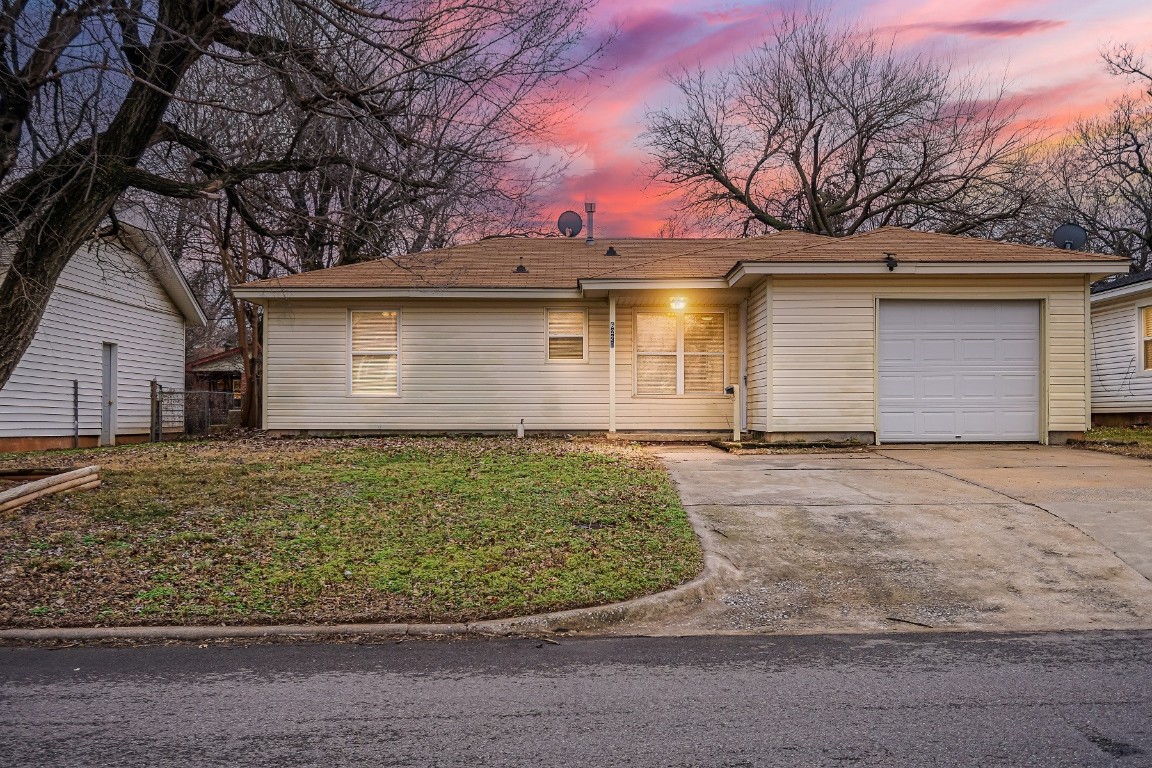6220 SE 7th Street, Midwest City, OK 73110 single story home featuring a lawn and a garage