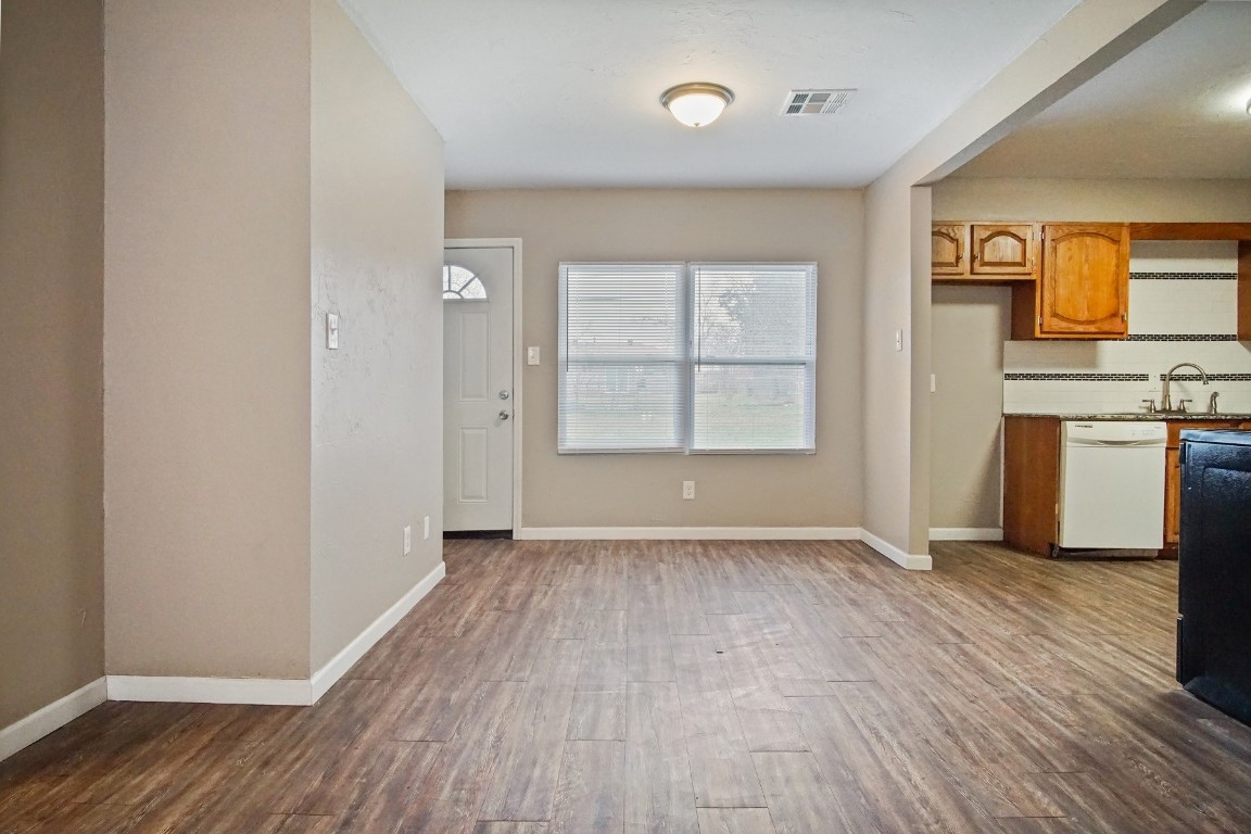 6220 SE 7th Street, Midwest City, OK 73110 interior space with sink, backsplash, dishwasher, and dark hardwood / wood-style flooring