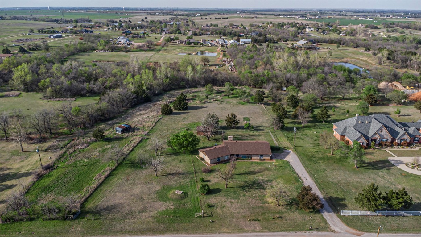 MULTIPLE OFFERS: FINAL AND BEST DUE WED. 4/17 AT 8:00 PM.  FOUR SIBLINGS, W/ONE OUT OF THE COUNTRY, WILL MAKE A DECISION BY SATURDAY, 4/20, AT 2:00 PM.   
One owner, custom built home in the desirable Deer Creek School District. Five beautiful acres with an orchard and large garden area that has grown the best tomatoes you could ever imagine!  Established asparagus beds, grapes & blackberries are a gardeners dream.  Much loved homestead, with room to update and make it your own.  The entryway opens into the living area, and your eye is drawn to the fireplace and rich wood built-ins on either side.  The corner brick planters are actually conducive to today's "green" look, but could be removed and the area opened up.  The eat-in kitchen area has elongated windows, bar seating and wood cabinets with faux butcher block counter tops. There is a dining or office area that leads to the covered back porch ( part of which was originally vented for HVAC and planned to be enclosed for additional living space). This would also be a great screened in porch. Off the kitchen is a bathroom with a shower, and the laundry room that leads to the attached 2 car garage ,with workshop area and storage room.  To the left of the entryway is the bedroom space, with 3 nice sized secondary bedrooms, 2 with walk in closets.  The main suite has a walk in closet and bathroom.  The sink area is open to the bedroom ( a 1970's thing)  but would be an ideal place to add a barn door!   The additional detached garage is great for storing tractors, mowers, and all those gardening implements, and the horse shed used to shelter Whiskers, the family horse. There is also a fenced in yard off the back porch that has housed dogs and chickens. Great value, and a beautiful place to watch those colorful Oklahoma sunsets!