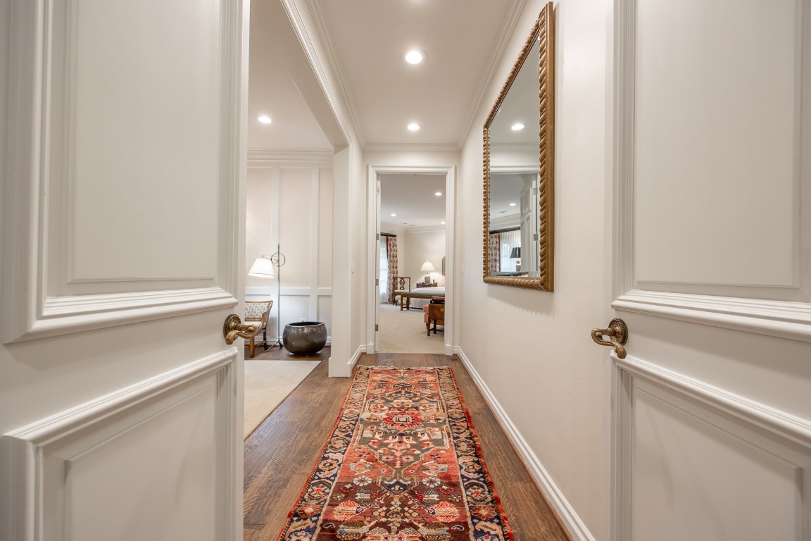 1601 Bedford Drive, Nichols Hills, OK 73116 hallway featuring light hardwood / wood-style flooring and ornamental molding