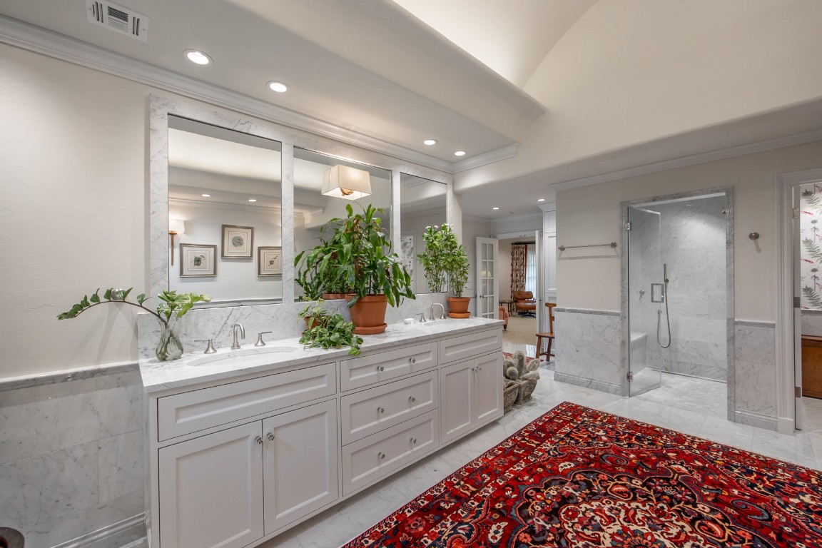 1601 Bedford Drive, Nichols Hills, OK 73116 bathroom featuring dual bowl vanity, crown molding, tile flooring, and walk in shower