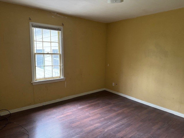 1713 N Quapah Avenue, Oklahoma City, OK 73107 unfurnished room featuring plenty of natural light and dark wood-type flooring