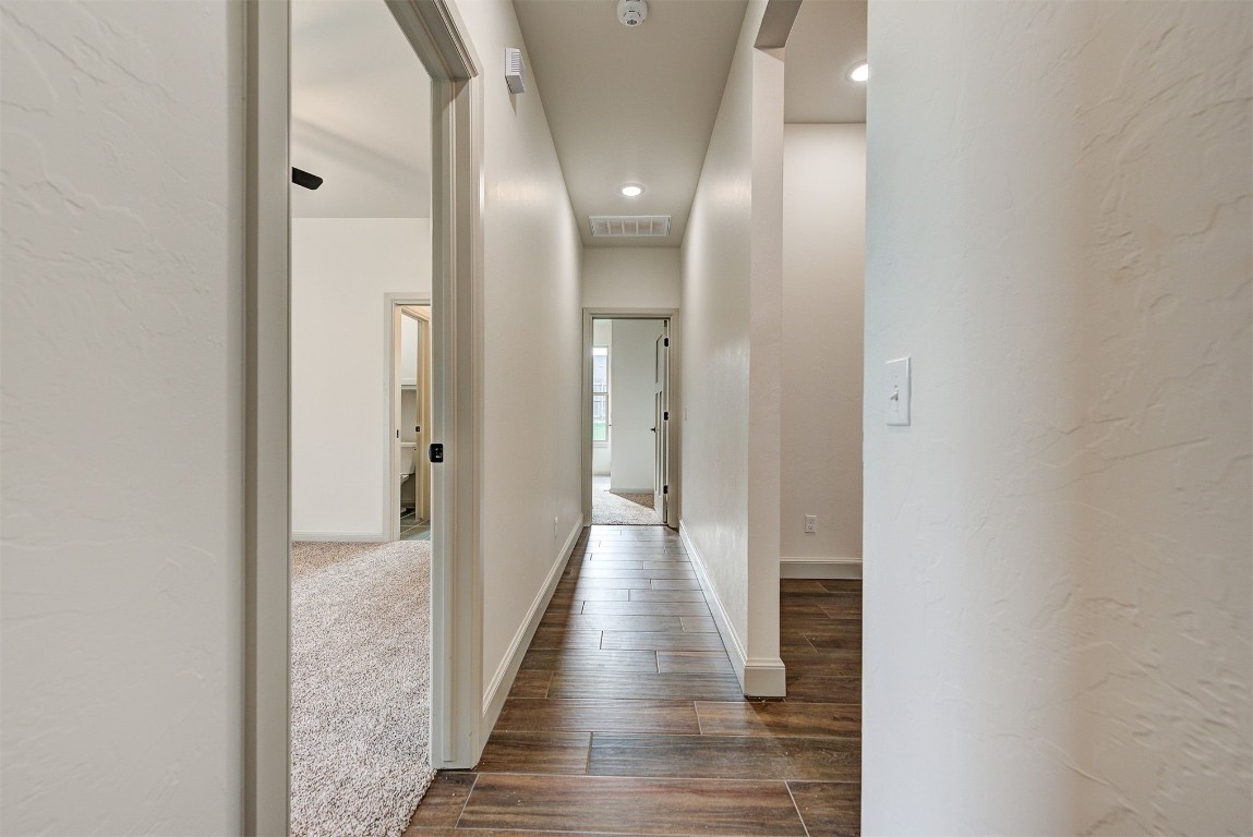5716 Goldstone Court, Mustang, OK 73064 corridor featuring dark wood-type flooring