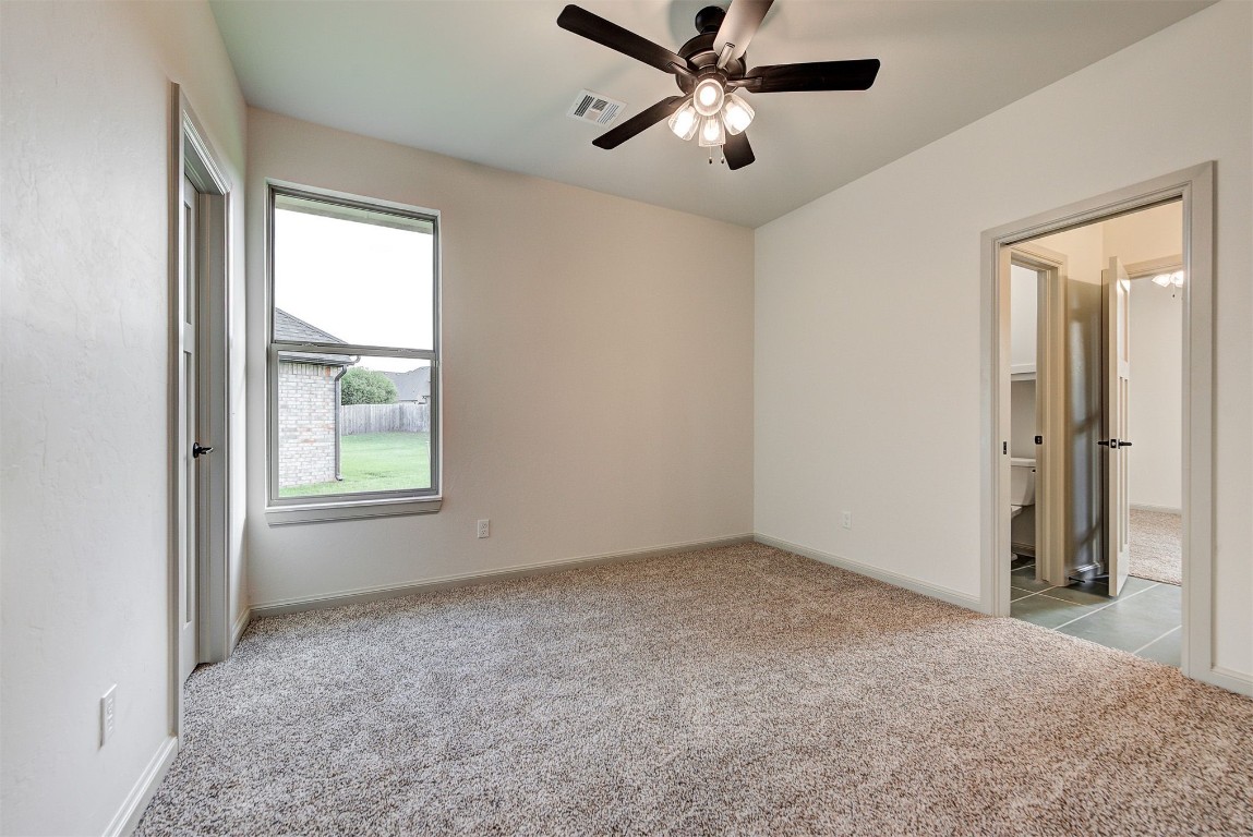 5716 Goldstone Court, Mustang, OK 73064 spare room featuring ceiling fan and light colored carpet