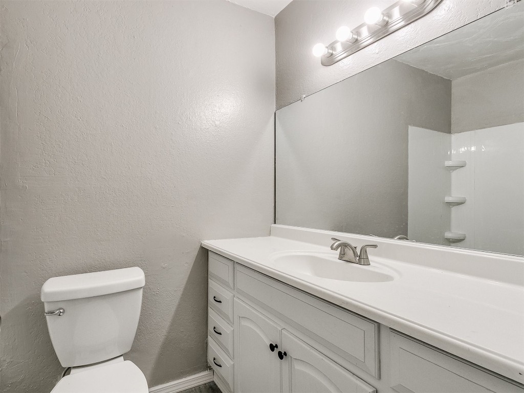 808 NW 113th Street, Oklahoma City, OK 73114 bathroom featuring toilet and vanity