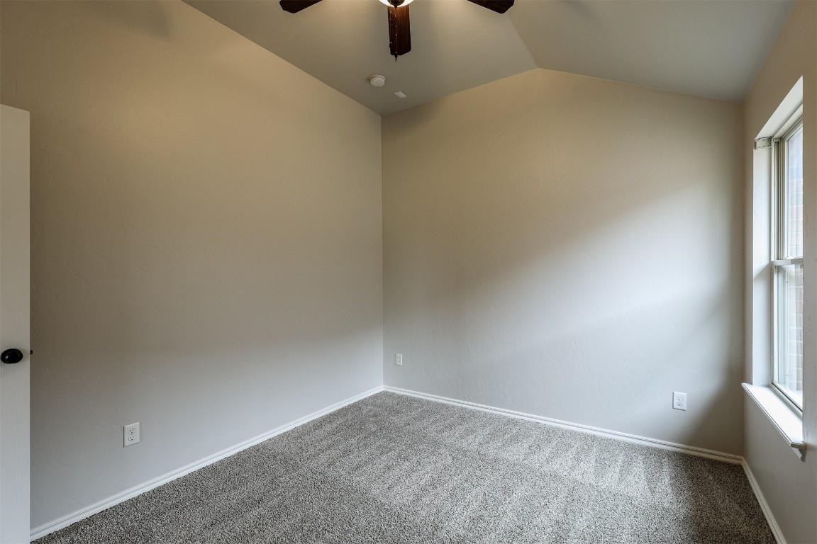 317 Partridge Run Road, Yukon, OK 73099 carpeted empty room featuring ceiling fan and vaulted ceiling