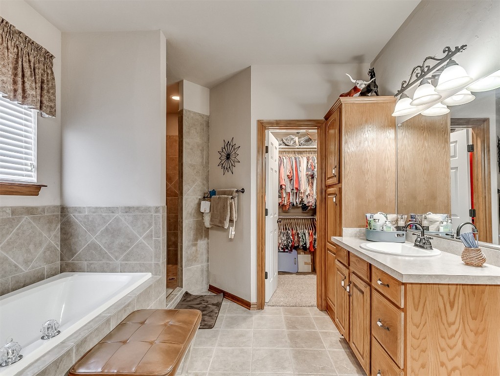 919 NW Fillmore Avenue NW Avenue, Piedmont, OK 73078 bathroom with tile flooring, vanity, and plus walk in shower