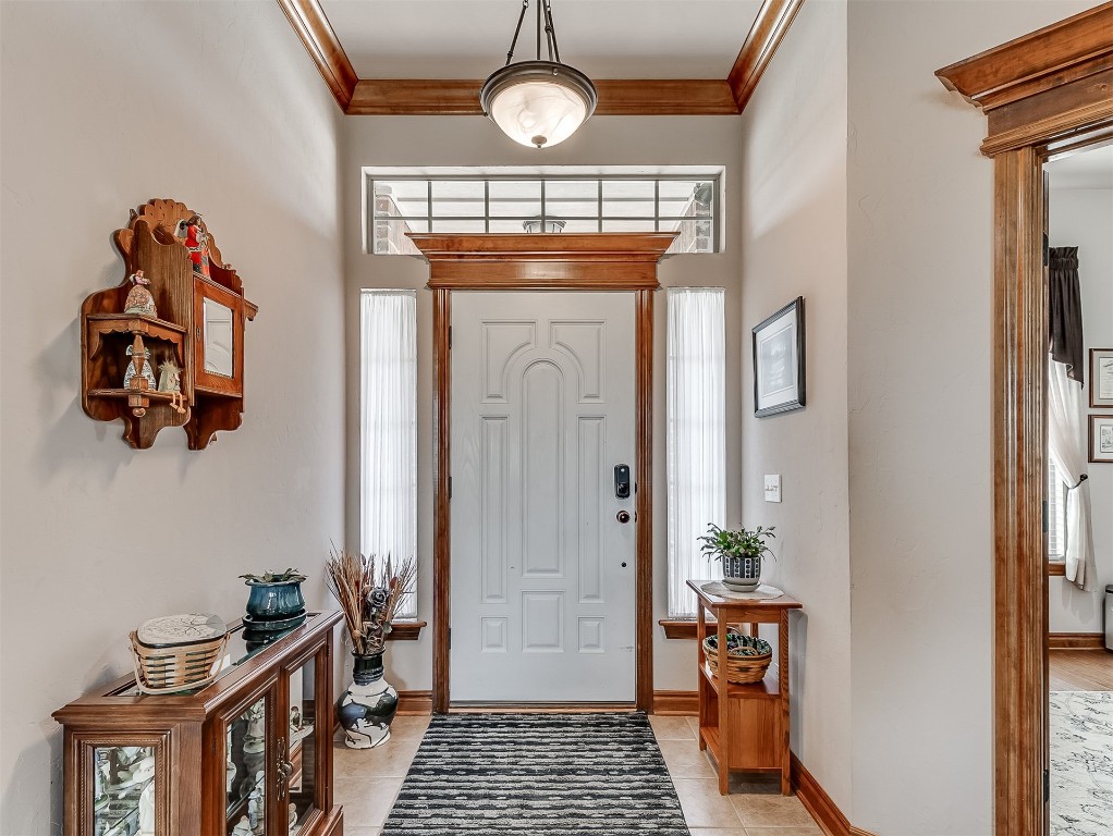 919 NW Fillmore Avenue NW Avenue, Piedmont, OK 73078 tiled foyer with ornamental molding and a towering ceiling