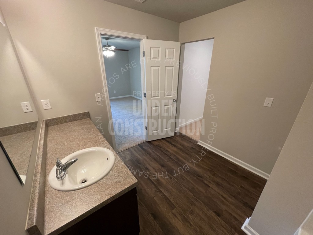 10516 Big Blue Drive, Oklahoma City, OK 73114 bathroom with ceiling fan, vanity, and hardwood / wood-style floors