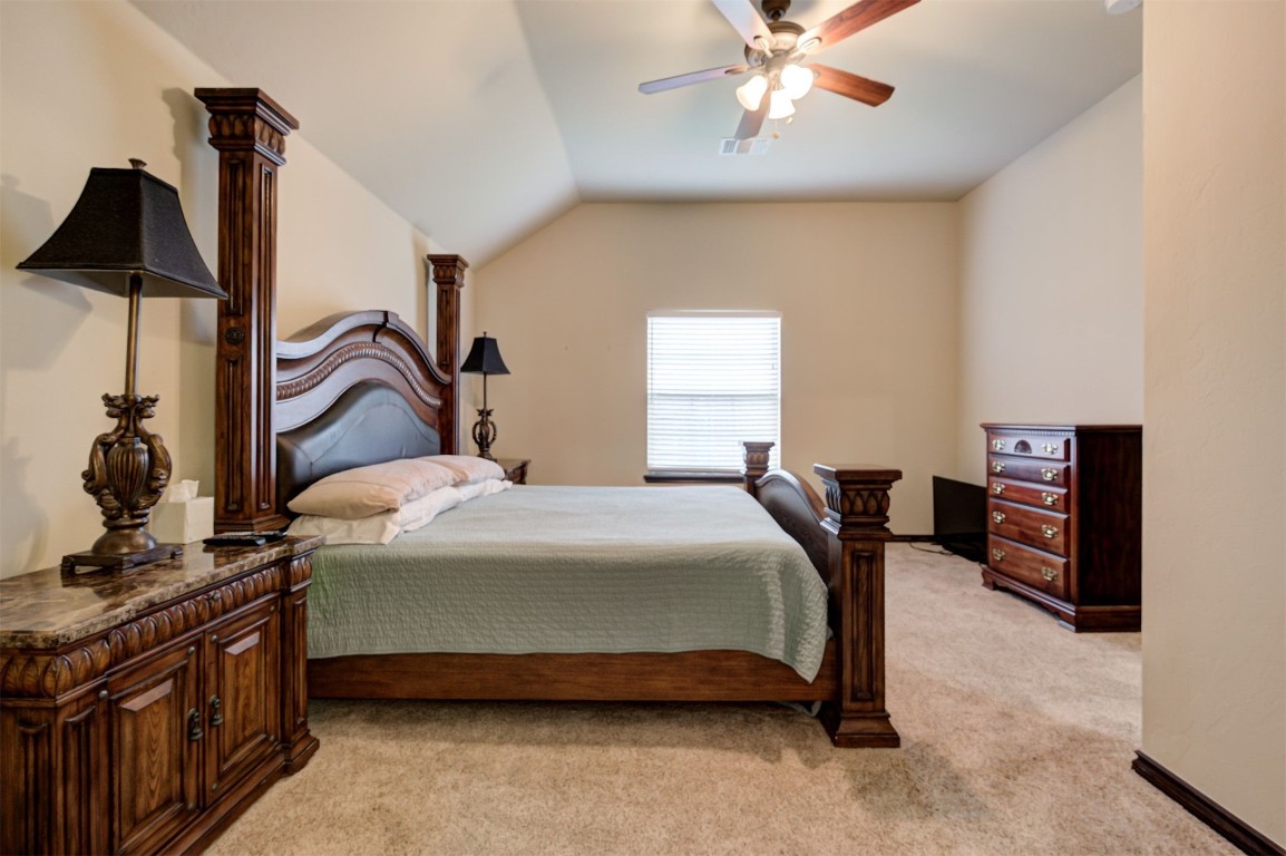 11748 SW 21st Street, Yukon, OK 73099 carpeted bedroom with ceiling fan and vaulted ceiling