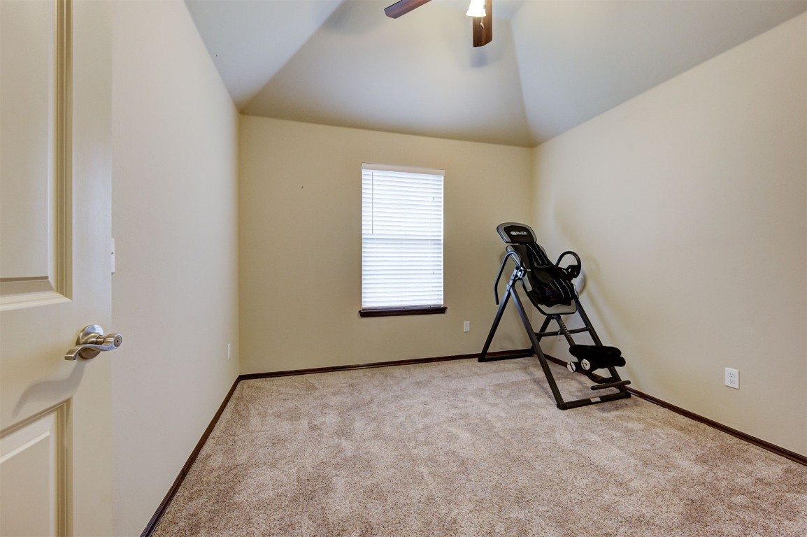 11748 SW 21st Street, Yukon, OK 73099 exercise area featuring vaulted ceiling, light carpet, and ceiling fan