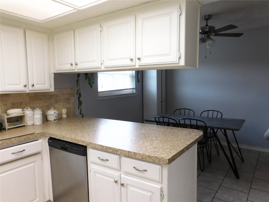 532 NW 140th Street, Edmond, OK 73013 kitchen with backsplash, white cabinets, ceiling fan, dishwasher, and tile floors