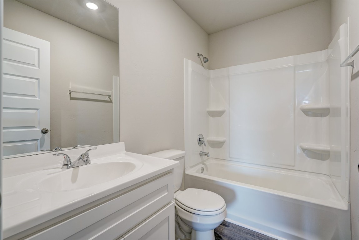 11920 Annette Drive, Yukon, OK 73099 full bathroom featuring shower / washtub combination, toilet, hardwood / wood-style flooring, and vanity