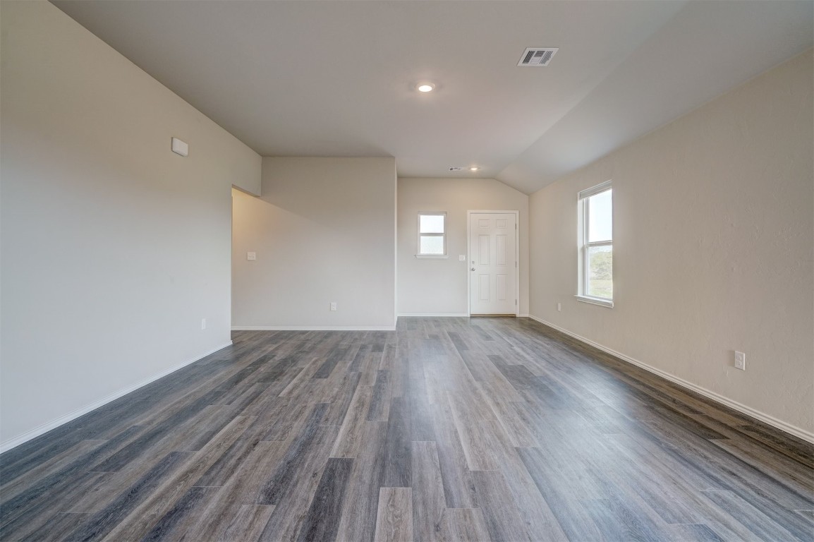 11920 Annette Drive, Yukon, OK 73099 empty room featuring dark hardwood / wood-style floors and vaulted ceiling