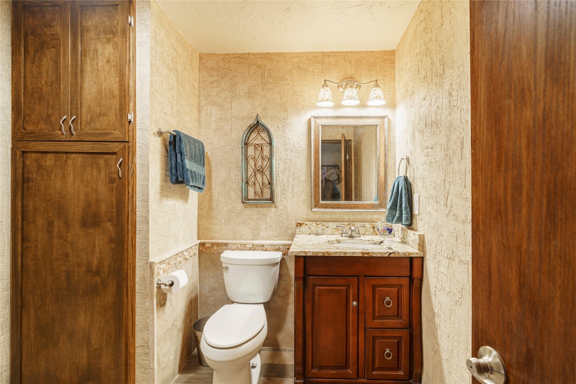 14655 NE 68th Street, Jones, OK 73049 bathroom featuring toilet, vanity with extensive cabinet space, and tile walls