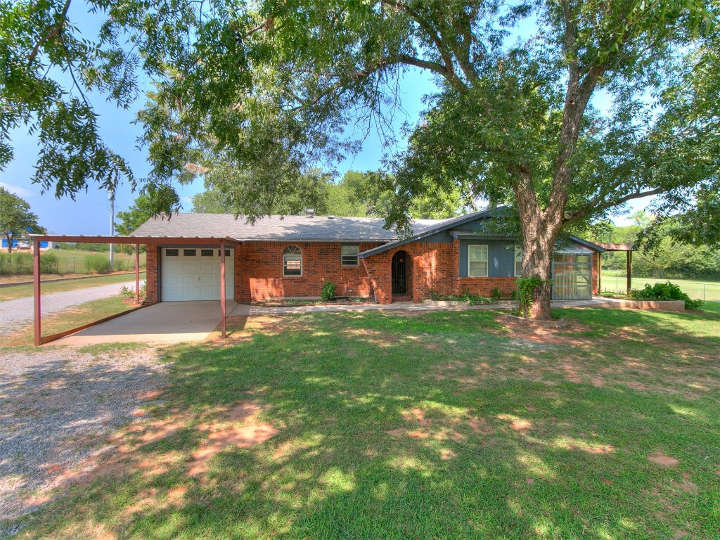 14655 NE 68th Street, Jones, OK 73049 single story home with a front yard and a garage