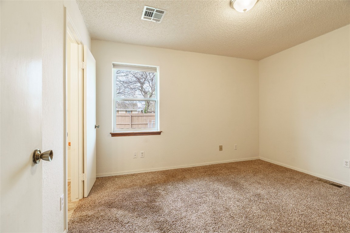 14655 NE 68th Street, Jones, OK 73049 carpeted empty room featuring a textured ceiling